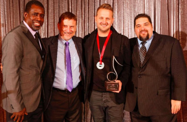 ><figcaption>Pictured (left to right): SESAC’s Trevor Gale & John Mullins, Ingram & SESAC’s Tim Fink.</figcaption></figure>
<p>SESAC, the nation’s most progressive performing rights organization, named Christian songwriter/producer Jason Ingram as SESAC’s Christian Songwriter of the Year at ceremonies held at the elegant Hillwood Country Club in Nashville. Sony/<strong>ATV</strong> Timber Publishing was named SESAC’s Christian Music Publisher of the Year. The awards recognize activity for songwriters and publishers in 2013.</p>
<p>A highlight of the evening occurred when sesac presented the legendary band Petra with its Legacy Award, marking the first time the award has been given in the Christian music genre. Previous recipients of this prestigious award have included Neil Diamond, Paul Shaffer and Jerry Cantrell of Alice In Chains. Petra also performed during the event, playing “Holy Is Your Name,” a newly-recorded single from the 40th Anniversary Reunion Tour.</p><div class='code-block code-block-8' style='margin: 8px auto; text-align: center; display: block; clear: both;'>
<img src=
