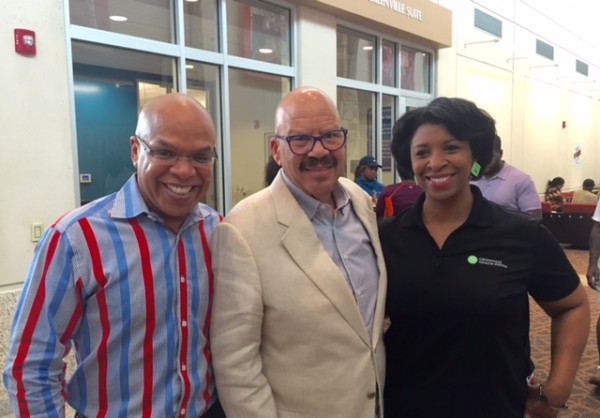 ><figcaption>Elroy Smith/Tom Joyner /Melinda Hudson Gillispie from The Green Health Systems</figcaption></figure>
<p>SummitMedia/Greenville-Spartanburg �Operations Manager, Elroy Smith paid Tom Joyner  the ultimate compliment by letting the world know how Tom Joyner  operates when he is amongst the people. The two radio veterans have known each other for years and “The Fly-Radio DJ” continues to impress Elroy by just doing what he does best outside of being on the air and that is connecting with the people. Check out Elroy’s comments about Tom Joyner  as he detailed his accounts of Tom’s time spent in Greenville.<br /><em>Radio legend Tom Joyner has had a notably successful career for a plethora of reasons. On Saturday, September 12, 2015, I witnessed the master at work. Mr. Tom Joyner , interacted eagerly and tirelessly with his listeners at this signature event, “TAKE A LOVED ONE TO THE DOCTOR” presented by 107-3 JAMZ in Greenville, South Carolina, along with Greenville Health Systems. He walked around the ENTIRE venue and greeted each listener one by one. In addition, every person that wanted a picture with Tom, he stopped to take a picture whenever asked. He not only posed for selfies with the listeners, but also with the volunteers/workers and graciously thanked them for working at the event… And with patience of a saint, he would even retake the picture if it wasn’t to their liking. Forever known as “The Fly-Radio DJ”, just two weeks prior, Tom was again in Greenville, SC., to host the “Battle of The Bands” with 10,000 people in attendance. Tom’s impeccable work ethic is not a norm for celebrities. On many occasions, whether it is a radio or musical celebrity, most set limits on time during a market visit to greet fans or clients. Quickly they are gone back to their hotel room. Of course, there are exceptional circumstances that security is needed, but it can be abused. However, Tom remains approachable, opting-out for personal security or a manager keeping his fans away. I have seen celebrities who are far less popular than Tom Joyner with a huge entourage or security guards, driving away their fans by blocking an opportunity for a fan to take a picture or simply shake their hand. Tom Joyner is the epitome of a professional. He has given his life to his listeners for over 40+ years, though he carries himself as if he is at the beginning of his career; always re-establishing his brand.</em><br /><em>Thanks Tom for showing your fans that you genuinely care about them and our communities. Many present and future radio personalities can learn from a veteran like you; never miss an opportunity to embrace your audience.</em><br /><em> His example is sincere and he lives up to his reputation of being (voice goes up 6 octaves) “The Hardest Working Man in Radio!”</em></p><div class='code-block code-block-8' style='margin: 8px auto; text-align: center; display: block; clear: both;'>
  <img src=
