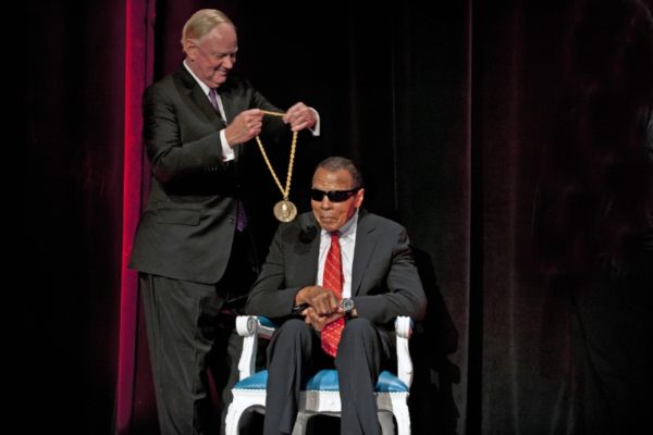 ><figcaption>University of Louisville President James R. Ramsey presenting <strong>Muhammad Ali</strong> with the inaugural Grawemeyer Spirit Award. (PRNewsFoto/University of Louisville)</figcaption></figure>
<p>The University of Louisville presented <strong>Muhammad Ali</strong> with the inaugural Grawemeyer Spirit Award in a public ceremony at the <strong>Louisville Palace</strong> attended by nearly 1,000.<br />The Grawemeyer Spirit Award was established to recognize an individual whose beliefs, actions and worldwide impact are in accord with Charles Grawemeyer’s reason for founding the awards program that bears his name. The UofL graduate, industrialist, entrepreneur and philanthropist wanted to recognize innovative ideas and inspire others to make the world a better place. He began the awards in 1984 with an initial endowment of $9 million. The first award was given in 1985.<br />“<strong>Although Mr</strong>. Ali and Charles Grawemeyer traveled very different paths in life, their destinations are similar,” said UofL President James Ramsey at the awards ceremony. “A world where every individual’s worth is cause for celebration; a world in which inspiration plus action can lead to transformation; a world where each of us can affect positive change by discovering our own greatness.”<br />The Grawemeyer Awards are given each year in five categories: music composition, education, religion, psychology and political science. The awards draw nominations from around the world and to date, more than $14 million has been given to 133 winners. The Grawemeyer Spirit Award includes a $100,000 honorarium, a portion of which Muhammad and <strong>Lonnie Ali</strong> have used to establish a leadership scholarship with the University of Louisville Baseball team.<br />“Muhammad is honored to be recognized by the University of Louisville and the Grawemeyer Awards Committee with the very first Charles Grawemeyer Spirit Award,” said <strong>Lonnie Ali</strong>. “In accepting this award, we are reminded that Muhammad’s life continues to inspire generations of people to discover and cultivate their own path to greatness and to use their talents and successes to empower others in communities all over the world. This award allows Muhammad’s legacy, like Charles Grawemeyer’s legacy, to live on through the people they inspire.”<br />Journalist and UofL alumnus Howard Fineman, global editorial director of the Huffington Post Media Group, was master of ceremonies for the event, which also included a photo retrospective by longtime Ali photographer Neil Leifer.</p><div class='code-block code-block-8' style='margin: 8px auto; text-align: center; display: block; clear: both;'>
  <img src=