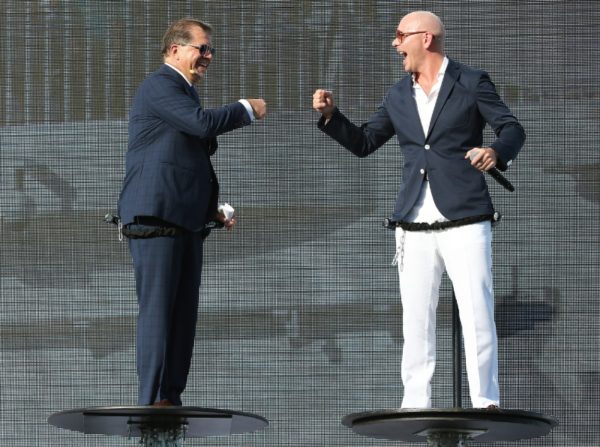 ><figcaption>Frank Del Rio and Pitbull celebrate with onstage “fist bump” at the Norwegian Escape christening ceremony. (PRNewsFoto/Norwegian Cruise Line)</figcaption></figure>
<p>The magnificent new Norwegian Escape � Norwegian’s largest ship and the first in its <strong>Breakaway Plus Class</strong> � was christened today in a stunning ceremony worthy of her size and status.<br />International music sensation Pitbull, who also served as GODFATHER for Norwegian Escape, thrilled fans and VIPs alike at the PortMiami pier side concert. The ship’s breathtaking hull artwork, created by Guy Harvey, who made a special guest appearance, served as the backdrop for the epic event.<br />Norwegian Cruise Line Holdings chief executive officer Frank Del Rio kicked off the festivities, where guests experienced an afternoon packed with fun and excitement in celebration of Norwegian Escape. Following a surprise opening act which featured acrobatic Parkour performers defying gravity (with the help of hidden trampolines built into the stage), national radio personality Froggy from the “Elvis Duran Morning Show” took the reins as event emcee, engaging the audience and introducing performers and special VIP guests, including Miami-Dade County Mayor Carlos Gimenez who discussed the positive impact Norwegian Escape will have on the local community, its residents and the economy.<br />Attendees were treated to a special sneak peek at the stellar entertainment Norwegian Escape has to offer as the casts of Tony Award-winning Broadway shows “After Midnight” and “Million Dollar Quartet” performed a selection of songs from each respective show, before Pitbull brought down the house with his hottest hits, including “Don’t Stop the Party”, “Fireball” and “Give Me Everything”.<br />DJ-led sing-alongs and a slideshow of themed guest photos snapped by roving photographers created a truly interactive event, where audience members quite literally became part of the show as photos of individual attendees holding signs customized with the place they’d choose to “Escape” were projected onto the jumbo screen on the main stage.<br />“Norwegian Escape represents a major moment for us � this is a true evolution of our brand,” said Andy Stuart, Norwegian Cruise Line’s president and chief operating officer. “Not only does she offer high caliber entertainment, quality dining and luxurious accommodations that significantly raise the bar for our fleet and <strong>puts</strong> her in a class of her own, but she exemplifies our renewed commitment to offering unparalleled freedom and flexibility to our guests.”</p><div class='code-block code-block-8' style='margin: 8px auto; text-align: center; display: block; clear: both;'>
  <img src=